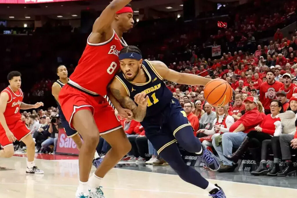 Michigan basketball player Roddy Gayle Jr. outperforms an OSU opponent for victory against the Buckeyes in Feb. 2025